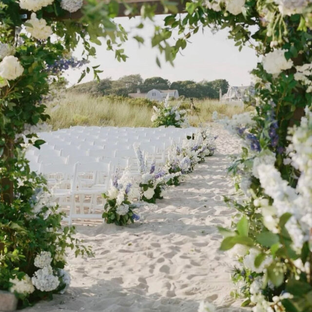 A beach set up with chairs for a wedding.