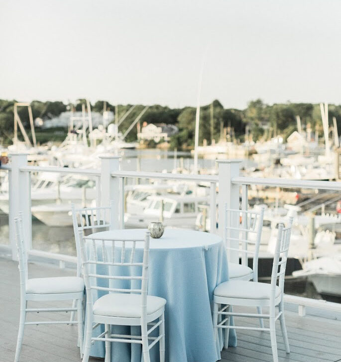 Table set for a wedding on a rooftop deck.