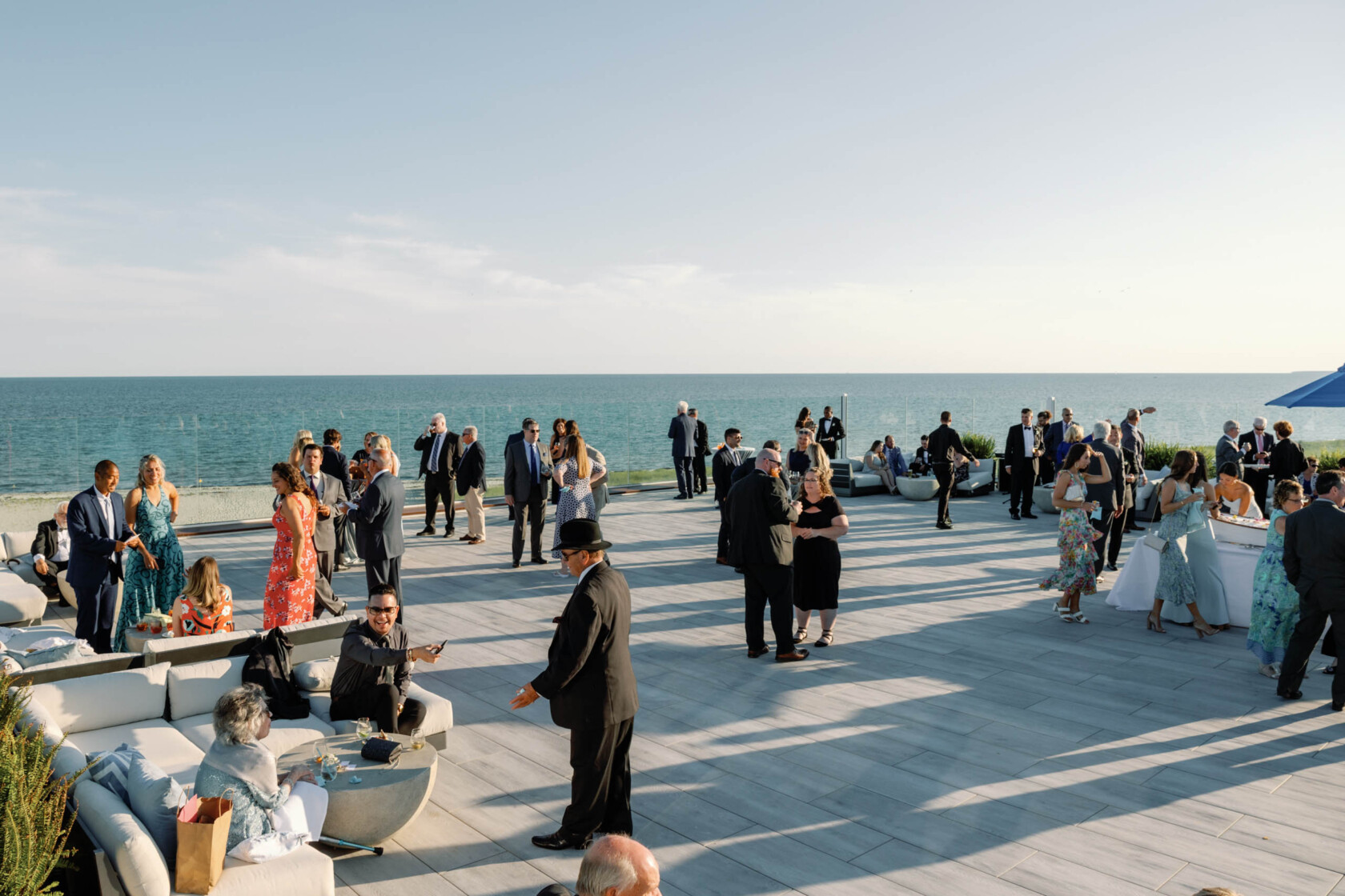 An event on a rooftop deck by the ocean.