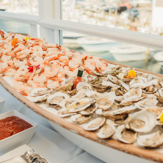 A raw bar with oysters and cocktail shrimp.