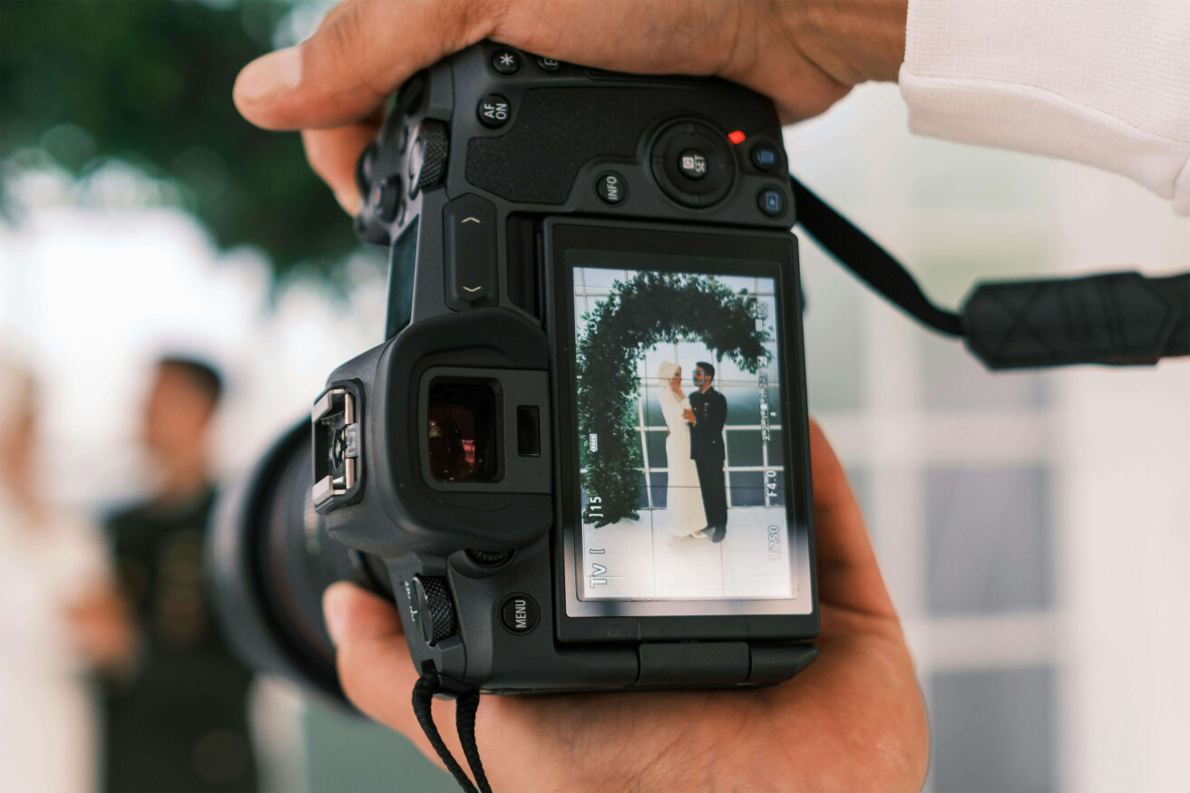 taking a wedding picture with a digital camera.